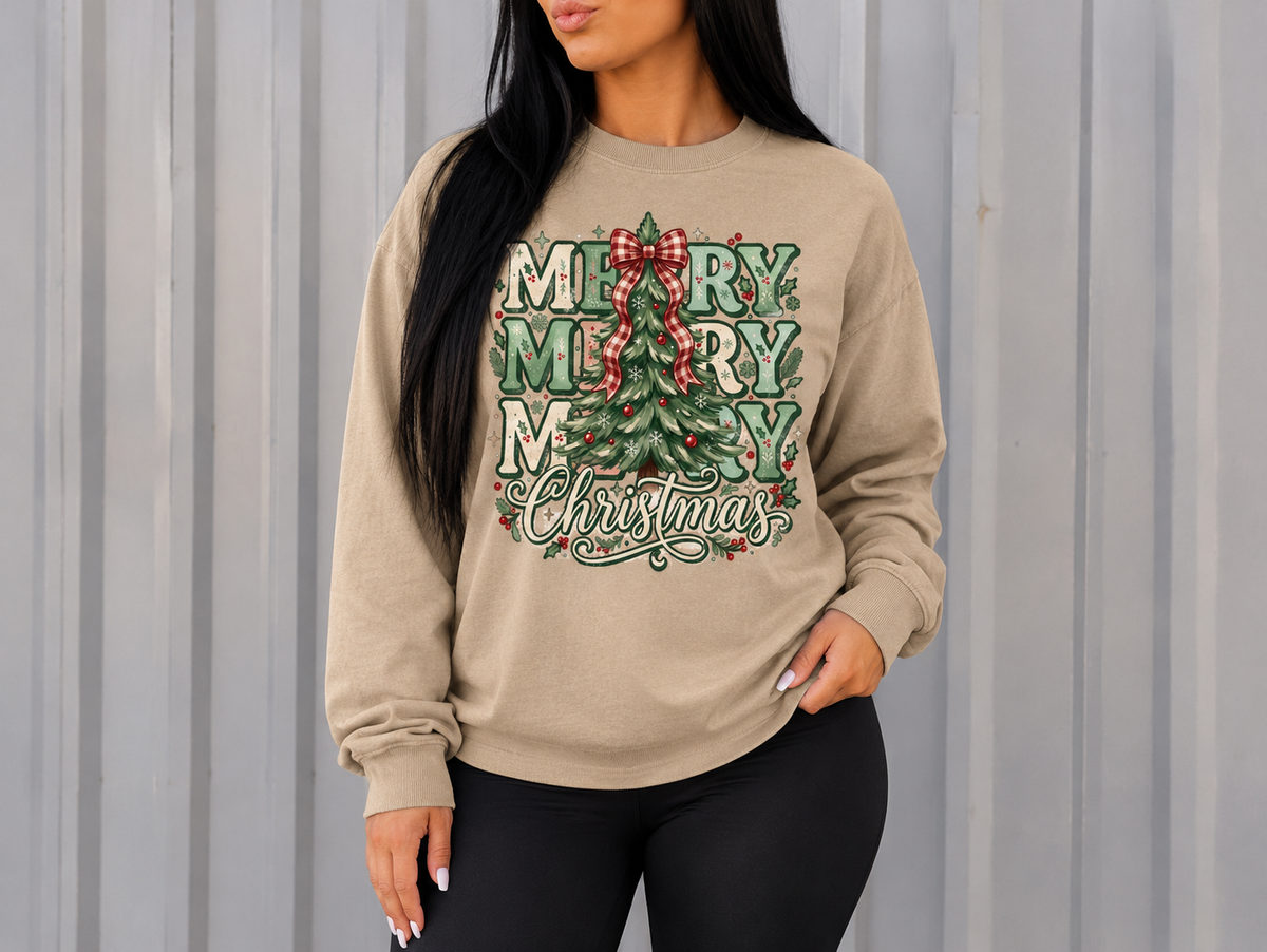 Sand-colored Christmas crewneck with green Merry lettering and a Christmas tree topped with a red bow